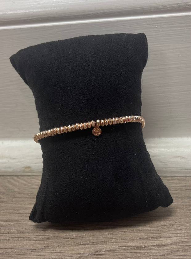 Rose gold stretch bracelet with charm